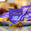 Purple packet of 'titi's Kitchen Chin Chin' snack on a blurred background
